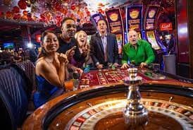 Mobile phone showing Dice Game interface with bet selection and payout table on raja main77.com